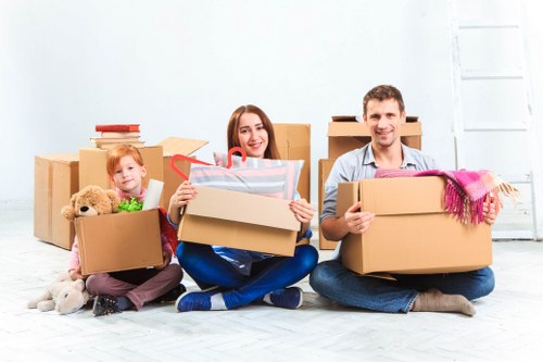 Removals team handling boxes safely during a Guildford house move